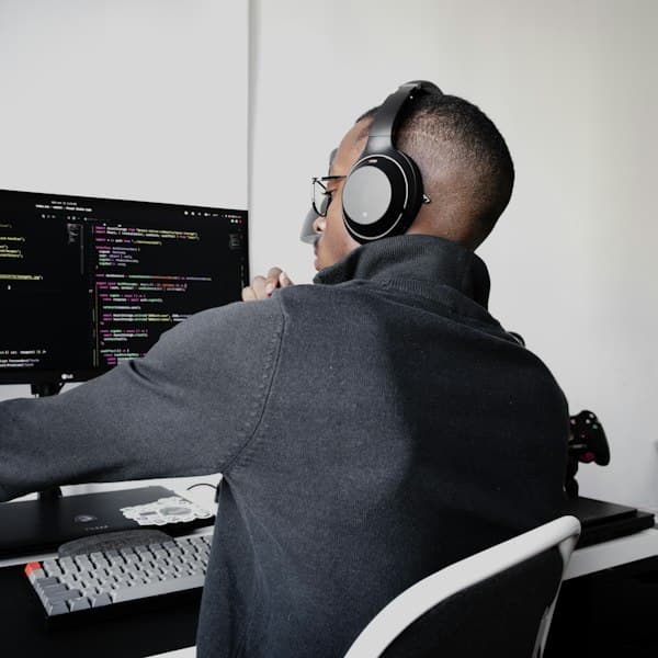 Engineer wearing headphones working at a computer