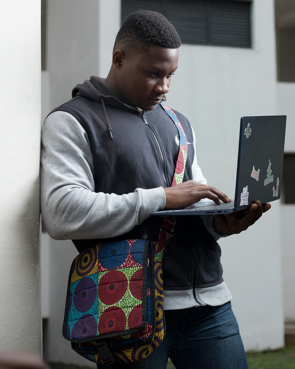 Student in a hoodie working on a laptop
