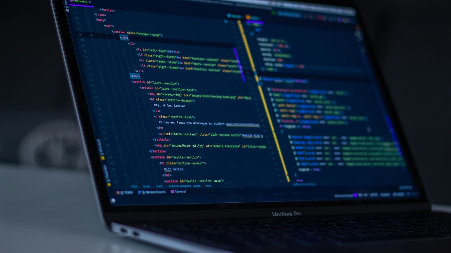Laptop screen showing code in a dark editor