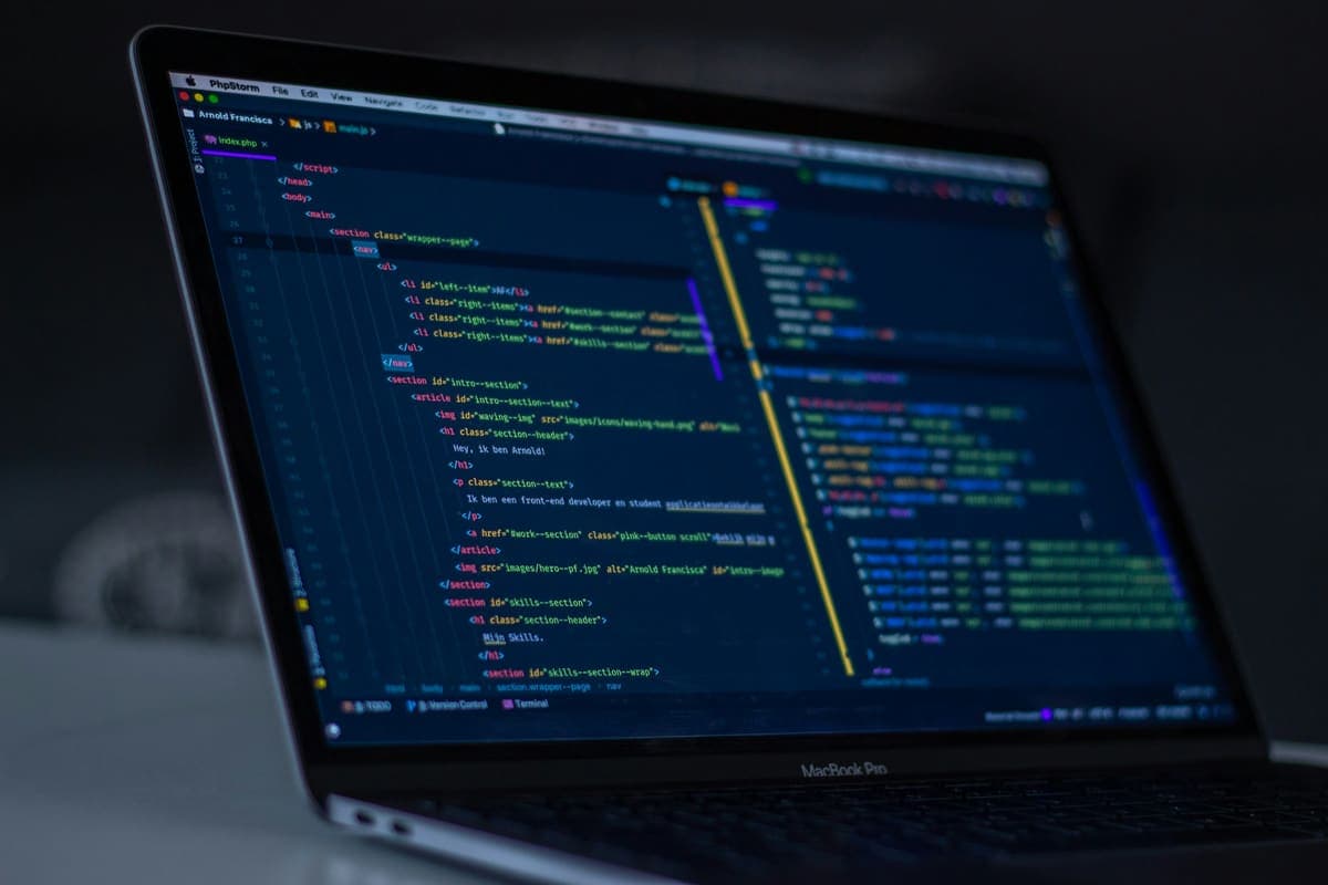 Laptop screen showing code in a dark editor
